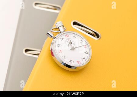 Yellow office folder on the chronometer. Stock Photo