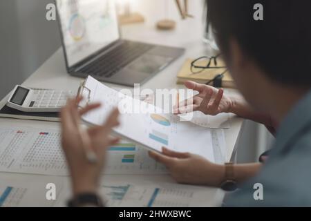 Analytics intelligence concept. Group of business people discuss current financial and economic on laptop for investment at the meeting. Stock Photo