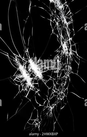 Broken glass on smartphone screen. Cracks on a black background. Stock Photo