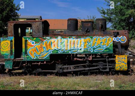 ‘Help’, 'Hilfe' and 'Pomoc', plea for help in three languages, English, German and Czech.  Graffiti on a rusty steam loco at the north east terminus of the Waldviertelbahn 760mm narrow gauge heritage railway network at Heidenreichstein, Gmund, Lower Austria. Stock Photo
