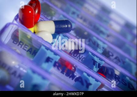 Daily doses pill box labeled with times of the day to remind the user ...