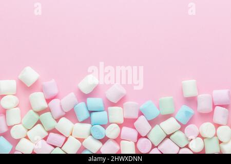 Frame made of marshmallows. Marshmallows on pink background Stock Photo