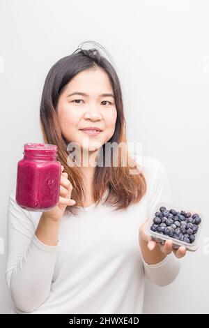 Blueberry smoothy drink bottle with asian women summer drink on white background Stock Photo
