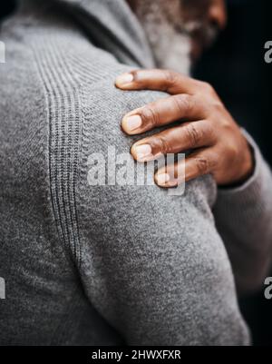 I think I hurt my shoulder back there. Shot of an unrecognizable senior man holding his shoulder in pain indoors. Stock Photo