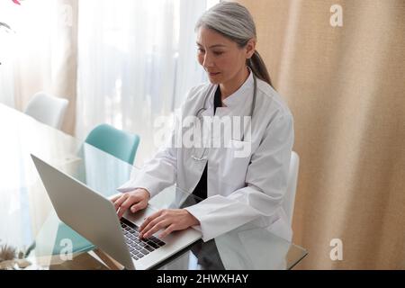 Medical specialist working on laptop at office Stock Photo