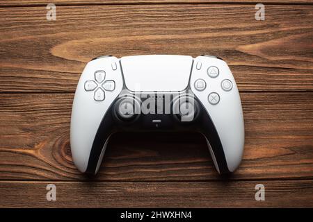 Dualsense ps5 controller on wooden background, gaming concept Stock Photo