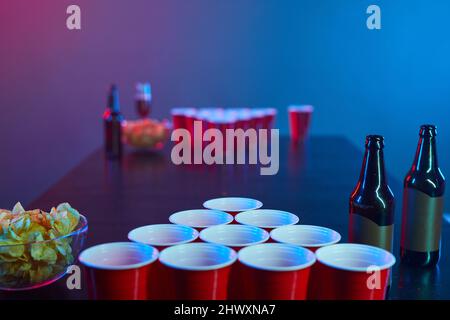 Background image of drinking game table at party with plastic cups and bottles, copy space Stock Photo