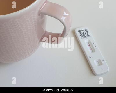 London, UK, 7 March 2022: A mug of Lemsip and a positive covid test. Since the government ended almost all coronavirus restrictions people who test positive with a rapid antigen test no longer need to get confirmation from a PCR test. While this saves money there is concern that new variants may not be identified. Anna Watson/Alamy Live News Stock Photo