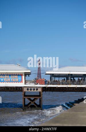 Blackpool Tower, the iconic landmark in the popular seaside resort of Blackpool, Lancashire, with buildings on South Pier in the foreground Stock Photo