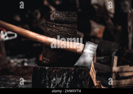 Axe in the log. Ax stuck in a tree stump Stock Photo