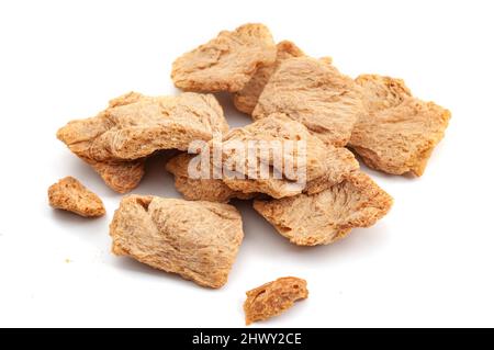 Vegetarian protein source vegan alternative to meats and biotechnology concept with group of raw dehydrated soy meat or soya textured chunks isolated Stock Photo