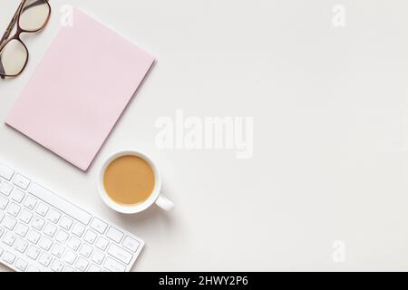 Desktop. Notepad keyboard cup coffee glasses on the table. Stock Photo