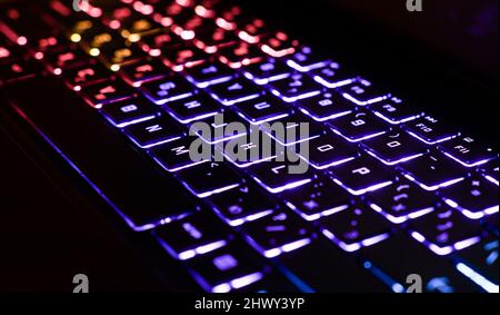Neon computer keyboard with color backlight. Computer video games, hacking, technology, internet concept. High quality photo Stock Photo