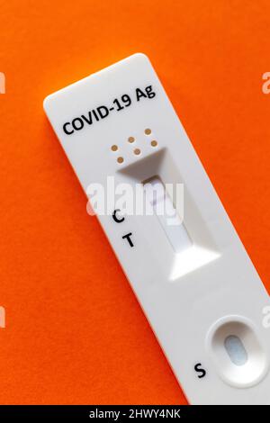 Negative test result by using rapid test device for COVID-19 on an orange background. Stock Photo
