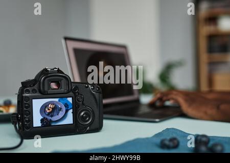 Close up of photo camera with food photography image on screen and laptop in background, copy space Stock Photo