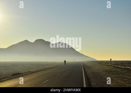 Morning road through arid landscape of Cabo de Gata Nijar Natural Park in Almeria southern Spain. Stock Photo