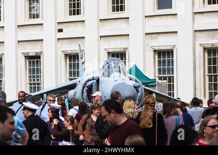 A Sea Harrier on display, surrounded by crowds of people, at the Old Royal Naval College in Greenwich, London, UK. Stock Photo