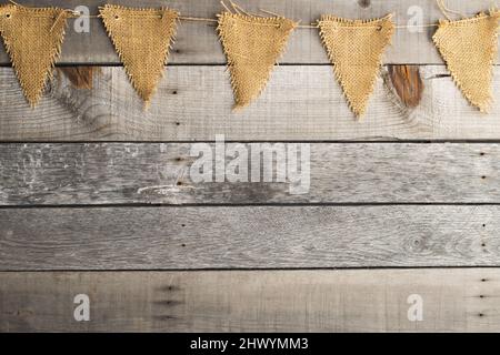 old wooden background with burlap pennant Stock Photo