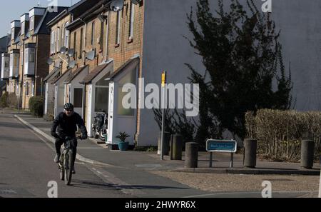 Man Cycling Passed Cottages Market Street Old Harlow Essex Stock Photo