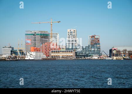 Ongoing redevelopment of the northern shore of the Ij waterway Amsterdam. Stock Photo