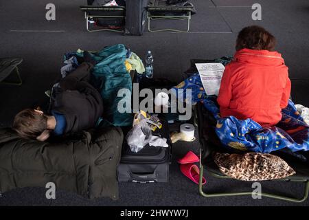 Krakow, Poland. 08th Mar, 2022. Refugees seen on the camp-beds in the sports hall of the Cracovia club where accommodation was organised for refugees from Ukraine coming to Krakow. Credit: SOPA Images Limited/Alamy Live News Stock Photo