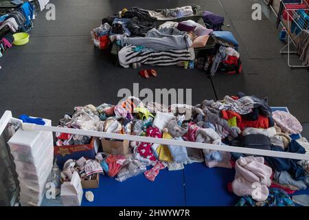 Krakow, Poland. 08th Mar, 2022. Clothes seen in the sports hall of the Cracovia club where accommodation was organised for refugees from Ukraine coming to Krakow. Credit: SOPA Images Limited/Alamy Live News Stock Photo