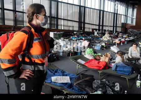 Krakow, Poland. 08th Mar, 2022. A paramedic seen in front of refugees in the sports hall of the Cracovia club where accommodation was organised for refugees from Ukraine coming to Krakow. Credit: SOPA Images Limited/Alamy Live News Stock Photo
