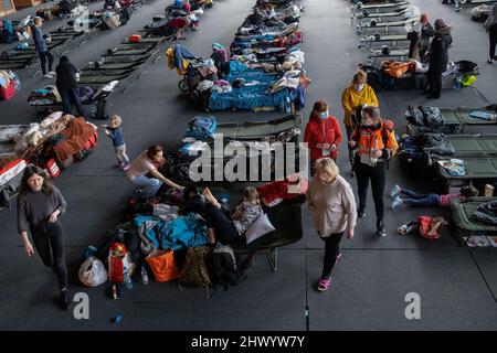 Krakow, Poland. 08th Mar, 2022. Refugees seen walking around camp-beds in the sports hall of the Cracovia club where accommodation was organised for refugees from Ukraine coming to Krakow. Credit: SOPA Images Limited/Alamy Live News Stock Photo
