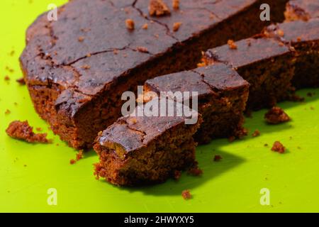 Sweet chocolate cake isolated on green background. Tasty creamy cake. High quality photo Stock Photo