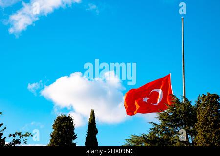 Half-staff Turkish Flag on the pole. Death anniversary of Ataturk or 10 november background photo. Stock Photo