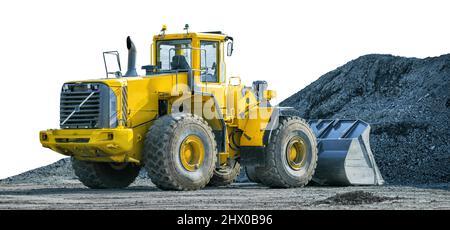 Yellow wheeled loader or excavator on front of pile of gravel isolated on white background Stock Photo
