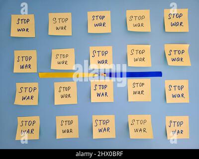 stickers with words on blue background close up. Flat lay. Concept of freedom and support. Protest action. Stop war. Stock Photo