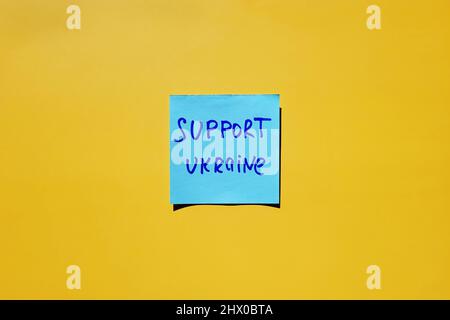 stickers with words on blue background close up. Flat lay. Concept of freedom and support. Protest action. Stop war. Stock Photo