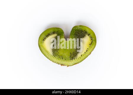 Horizontal flat lay picture of a kiwi cut in half with heart shape Stock Photo