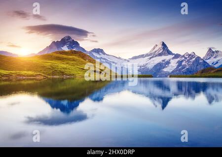 Alpine view of the Mt. Schreckhorn and Wetterhorn. Popular tourist attraction. Dramatic and picturesque scene. Location place Bachalpsee in Swiss alps Stock Photo