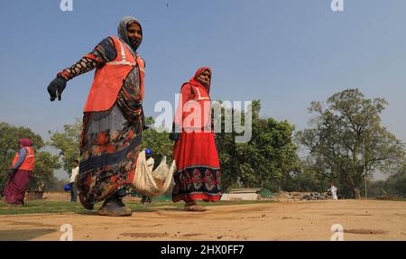 Women workers seen carrying sand on the occasion of International Women's Day in New Delhi. Stock Photo