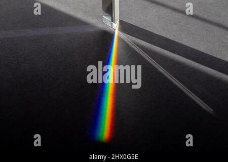 Light Rays Entering Prism and Creating Shadows and Rainbow Refraction Stock Photo