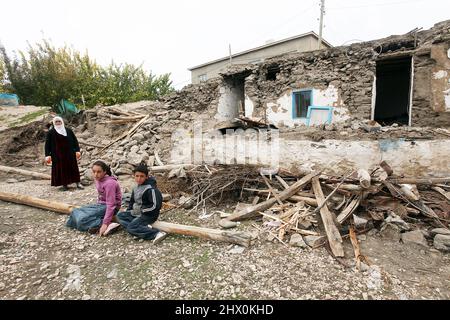 VAN, TURKEY - OCTOBER 25: Earthquake victims family in front of the their destroyed houses in the Van-Ercis Earthquake on October 25, 2011 in Van, Turkey. Stock Photo