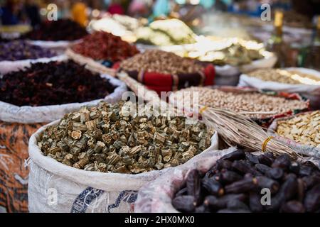 Variety organic okra and dates in sacks on sale on a farmers market. Traditional arabic market Stock Photo