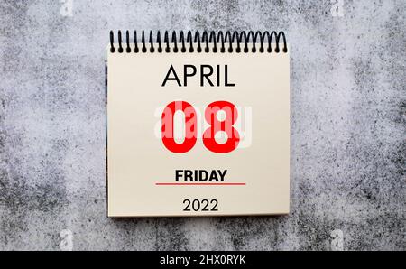 April 8. 8th day of month, calendar date. Stand for desktop calendar on beige wooden background. Stock Photo