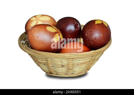 Easter basket full of cracked Easter eggs isolated on white background Stock Photo