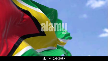 Detail of the national flag of Guyana waving in the wind on a clear day. Guyana is a country on the northern mainland of South America and the capital Stock Photo