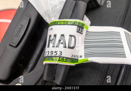 A suitcase with an airline baggage tag shows the three letter airport code for Madrid Barajas Airport, Spain Stock Photo