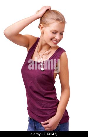 Her attitude embodies freedom. Studio shot of a beautiful young woman standing with her hand in her hair isolated on white. Stock Photo