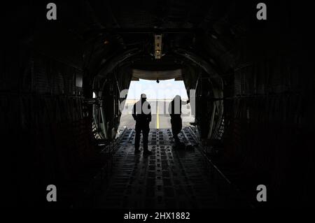 A jumpmaster and Sergeant Major from the Botswana Defense force takes a moment to view the flightline in a C-130 after a freefall jump over Thebephastwa Airfield, Botswana, March 1, 2022. Military freefall jumps are conducted from altitudes between 10,000 to 25,000 feet. Members of the 3rd Special Forces Group works with the partner forces to help maintain jump qualifications and teach insertion techniques. (U.S. Air Force photo by Staff Sgt. Joshua De Guzman) Stock Photo