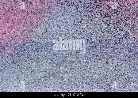 spray of colored aerosol paint on a grey metallic surface. abstract background, texture Stock Photo