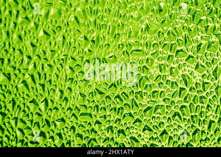 Ribbed decorative glass surface of green colour, background, texture Stock Photo