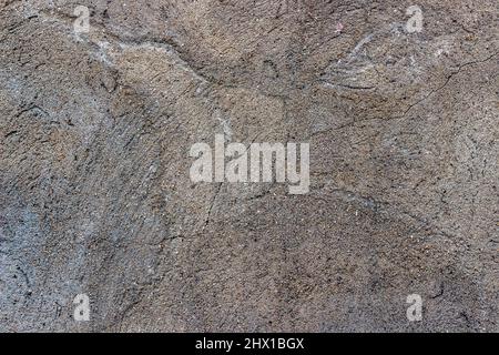 Texture of a concrete wall based on sand and cement with a crack. Abstract background, seamless texture. Stock Photo