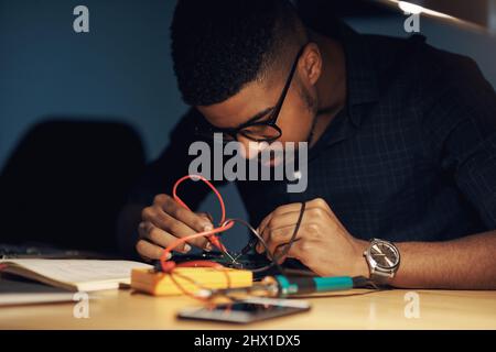 The expert to tackle any tech challenge. Shot of a young technician repairing computer hardware. Stock Photo