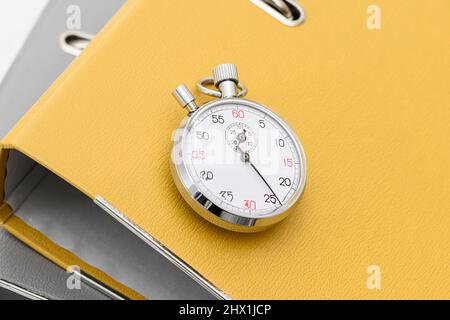 Yellow office folder on the chronometer. Stock Photo